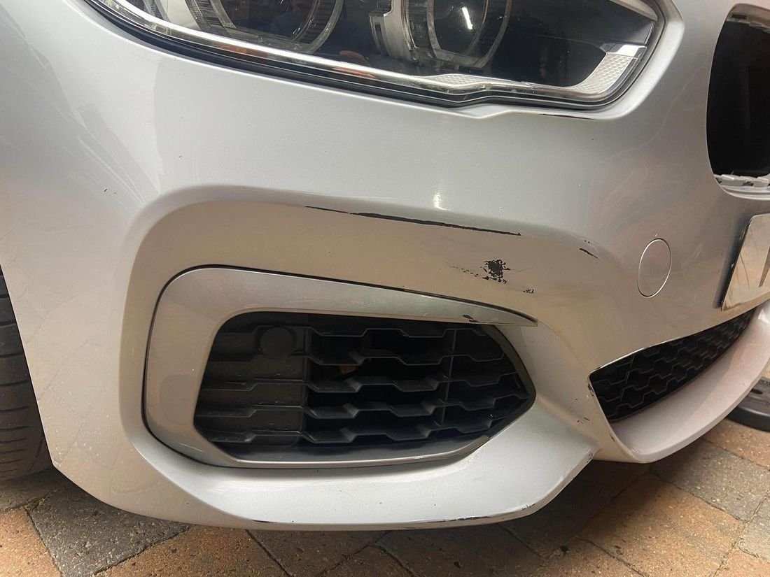 Before: Scraped BMW bumper repaired and refinished