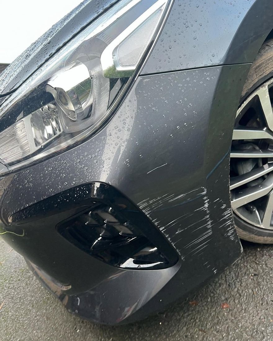 Before: Scuffed front wing and bumper corner repaired